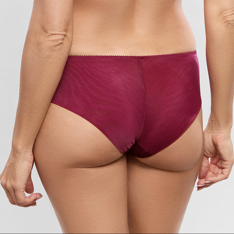 A woman shown from the back wearing a matching burgundy lingerie set, consisting of a bralette with lace straps and high-waisted briefs, against a light gray studio background.