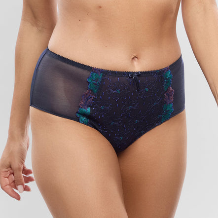 A model wearing a two-piece lingerie set featuring a navy blue lace bra and matching high-waisted briefs with teal and purple floral embroidery.