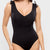 Black swimsuit worn by a model on a light gray background