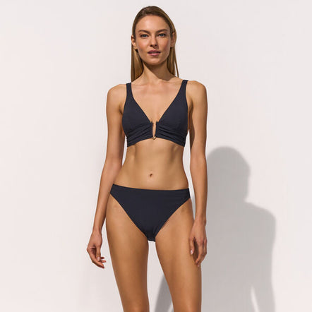 Woman wearing a black bikini on a white background