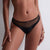 Black bikini bottom worn by a person on a neutral background