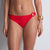 Red bikini bottom worn by a person on a plain background