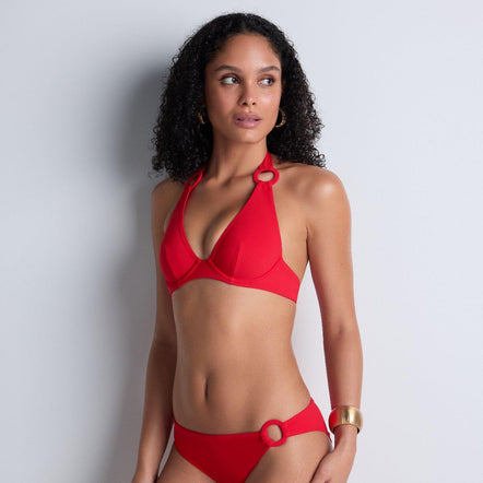 Woman wearing a red bikini against a light gray background