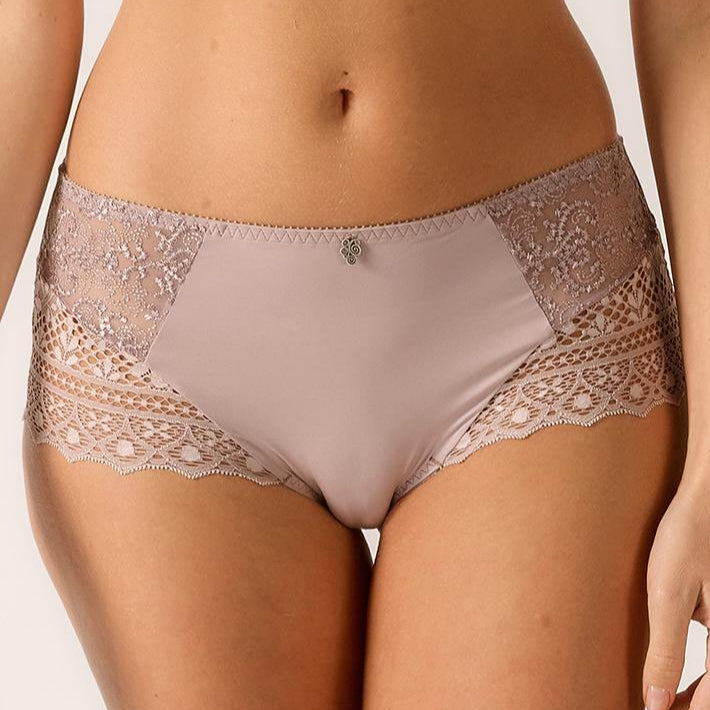Beige lace underwear on a plain background