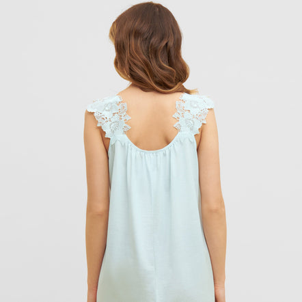Light blue sleeveless dress with lace details on a white background