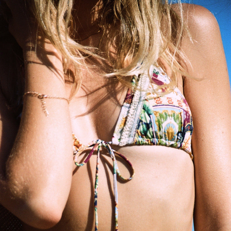 Person wearing a colorful bikini with 'Watercult' branding.