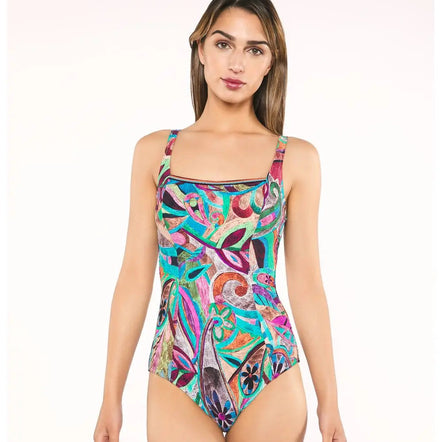 Woman wearing a colorful patterned swimsuit on a white background