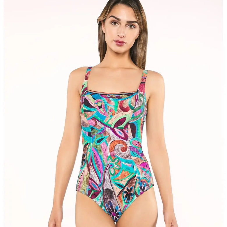 Woman wearing a colorful patterned swimsuit on a white background