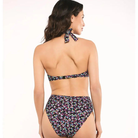 Woman wearing a floral bikini set on a white background