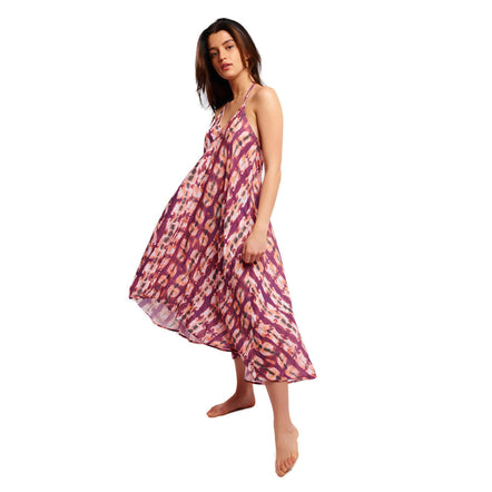 Woman wearing a pink and purple patterned dress on a white background