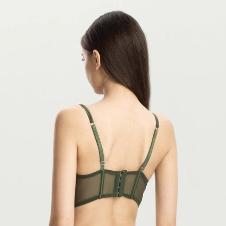 A woman shown from the back wearing an olive green mesh lingerie set against a plain light gray studio background.