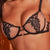Black lace lingerie being worn by a person with a blurred background