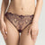 A model wearing a dark purple lace lingerie set, featuring a sheer bralette with floral lace detailing and matching high-cut lace panties, shown against a light gray studio background.