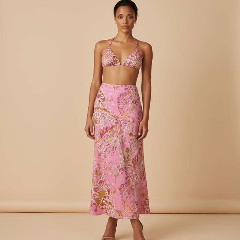 Woman wearing a pink floral outfit against a beige background