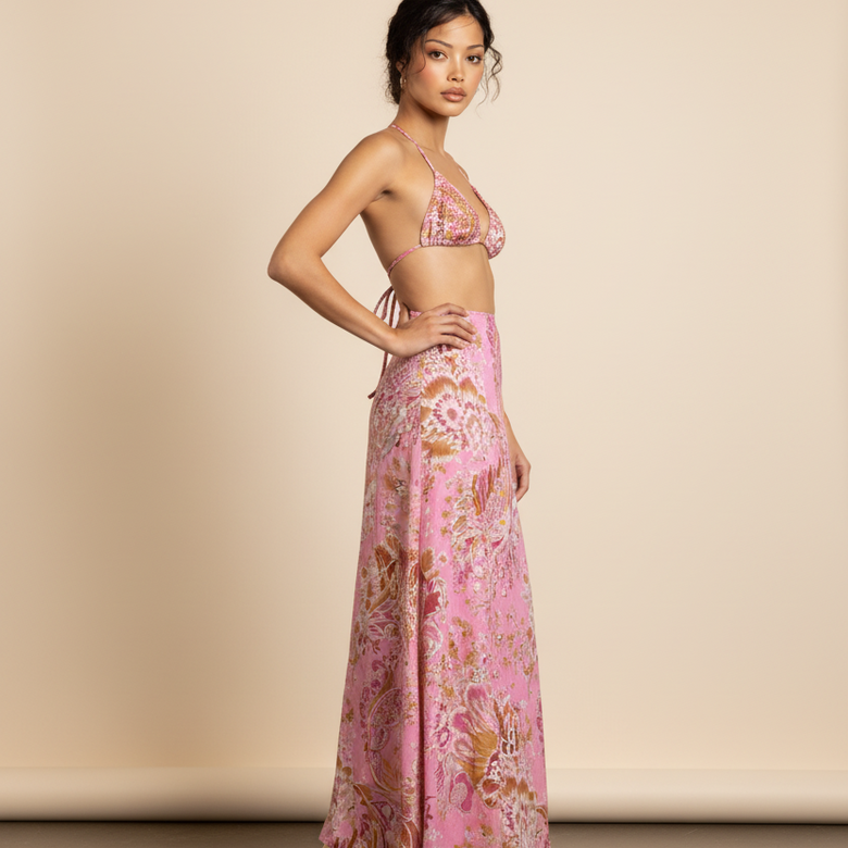 Woman wearing a pink floral outfit against a beige background