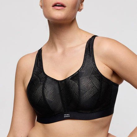 Black sports bra with geometric pattern on a neutral background